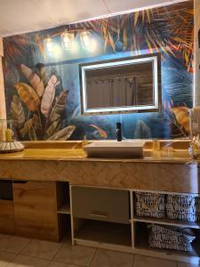 a bathroom with a sink and a large mirror at Apartamento Riviera, lake Panajachel in San Jorge La Laguna