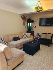 a living room with a couch and a table at Apartamento Riviera, lake Panajachel in San Jorge La Laguna