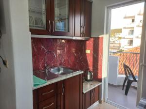 a kitchen with wooden cabinets and a sink at Vila Ester in Ksamil +192 photos