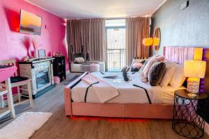 - une chambre avec un grand lit aux murs roses dans l'établissement 50 Shades Of Grey - Romance Suite! Couples Retreat 717, à Myrtle Beach