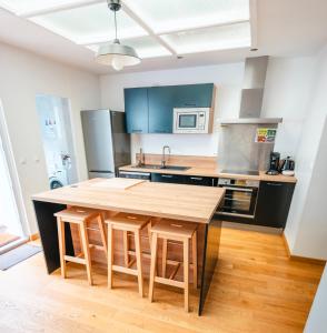 a kitchen with a wooden table and some appliances at maison R&vâmes in Calais +11 photos