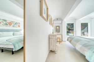 a white bedroom with a bed and a desk at Villas Andaluzas Retreat in Estepona +41 photos
