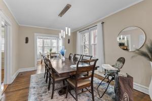 a dining room with a table and chairs and a mirror at Forest Park Oasis by JZ Vacation Rentals in Tower Grove