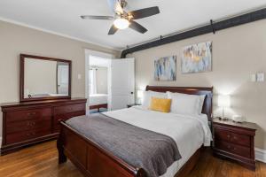 a bedroom with a large bed and a ceiling fan at Forest Park Oasis by JZ Vacation Rentals in Tower Grove