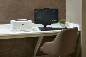 a computer sitting on a desk with a printer at SpringHill Suites by Marriott Atlanta Six Flags in Lithia Springs +10 photos