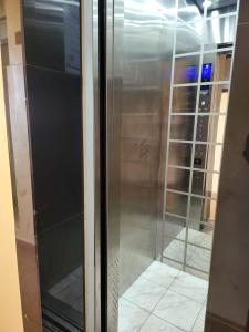 a stainless steel refrigerator with a glass door at Casa Bellà section 58 in Nakuru