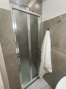 a shower with a glass door and a towel at La Casina appartamento vacanze Assisi in Bastia Umbra +26 photos