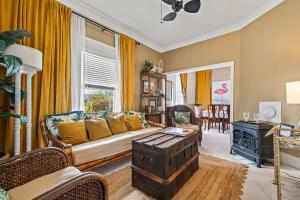 a living room with a couch and a table at Old Carrabelle Hotel Flamingo Suite in Carrabelle