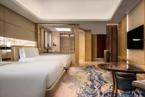 Voodi või voodid majutusasutuse JW Marriott Hotel Macau toas