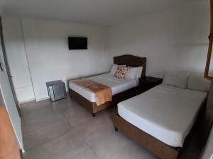 Postel nebo postele na pokoji v ubytování Ecohotel Guaduales Nature