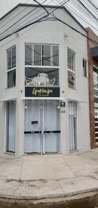 a building with two garage doors and a sign on it at Apartamento com Vista Panorâmica in São Gabriel