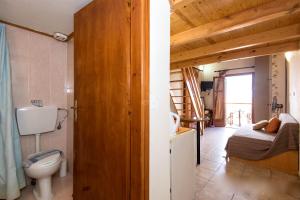 a bathroom with a toilet and a bed in a room at Barbara Studios in Rethymno +101 photos