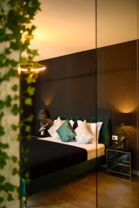 - une chambre avec un lit doté d'oreillers blancs et bleus dans l'établissement Elite Studio, à Bucarest