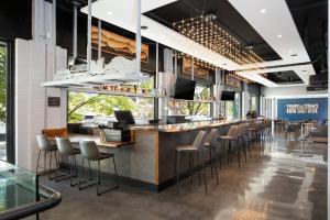a bar in a restaurant with a bunch of stools at Hotel Indigo Chattanooga - Downtown by IHG in Chattanooga
