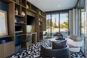 a living room with couches and a table and chairs at Hotel Indigo Chattanooga - Downtown by IHG in Chattanooga
