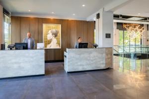two people at a reception desk in a lobby at Hotel Indigo Chattanooga - Downtown by IHG in Chattanooga