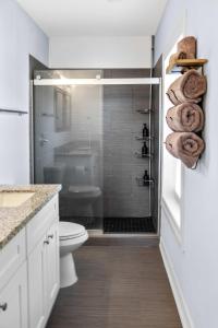 un bagno con doccia, WC e asciugamani di Modern 3BD Getaway Close to Downtown& NRG I Wi-Fi & Parking a Houston