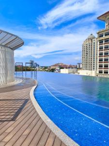 a swimming pool on the roof of a building at Netflix Two Bedroom Troika Kota Bharu Homestay 296 in Kota Bharu