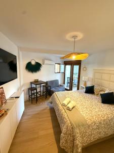 a bedroom with a large bed and a dining room at El Nido de Mijas in La Cala de Mijas
