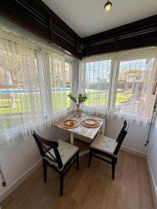 a dining room with a table and chairs and windows at El Nido de Mijas in La Cala de Mijas +18 photos