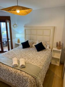 a bedroom with a large bed with two towels on it at El Nido de Mijas in La Cala de Mijas