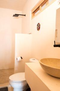 a bathroom with a sink and a toilet at Casa Miztli in Brisas de Zicatela +15 photos