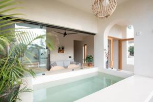 a swimming pool in the middle of a house at Casa Miztli in Brisas de Zicatela