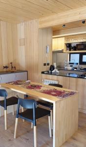 eine Küche mit einem großen Holztisch und Stühlen in der Unterkunft Alquiler Turistico Centro Villa la Angostura in Villa La Angostura
