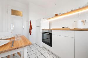 a white kitchen with a counter and a sink at Cozy Mozy - Gemütliche Wohnung in Bremen Hemelingen in Bremen