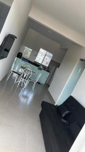 a living room with a glass table and chairs at Residencial Mangueiral in Paracatu