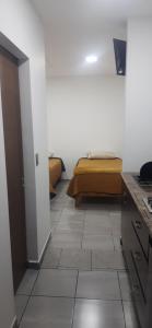 a room with a bed and a tiled floor at Estudios Quintana in Arandas