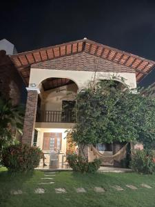 a house with an archway in front of it at Casa de Praia com vista mar e Foz do rio in Aquiraz
