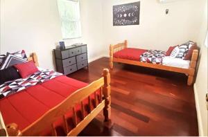 a bedroom with two beds and a chalkboard on the wall at Tranquil Family Home Near BWI Casino Shopping & Fire Pit in Severn