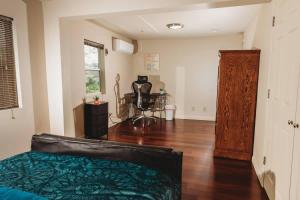 a living room with a bed and a chair in it at Tranquil Family Home Near BWI Casino Shopping & Fire Pit in Severn