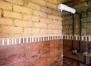 a bathroom with a shower with a brick wall at Hotel - Finca Casa de Teja - Subachoque in Subachoque +35 photos