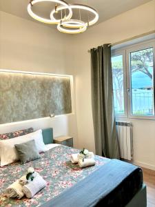 a bedroom with two stuffed animals on a bed at Guest House Maison Margot in Fiumicino