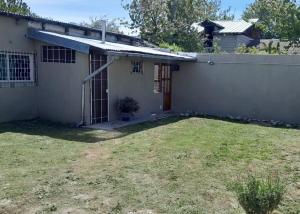 a house with a yard in front of it at Casita Las Lavandas in El Bolsón