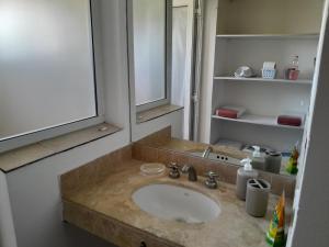 a bathroom with a sink and a mirror at Duplex en salta in Destilería Chachapoyas +19 photos