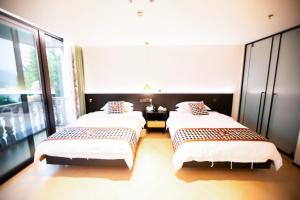 Llit o llits en una habitació de Xiyuyanyiyu B&B