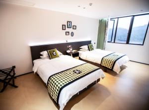 Llit o llits en una habitació de Xiyuyanyiyu B&B