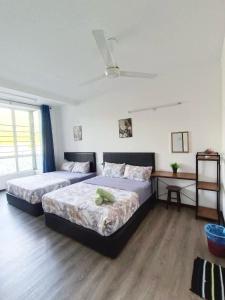 a bedroom with two beds in a room at IRDINA HomestayMuslim's 2 at Emerald Avenue Brinchang Centrum in Brinchang
