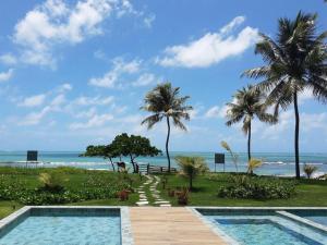 a resort with a swimming pool and the beach at Kauai Beach Residence 403 in Tamandaré