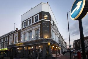 Un edificio in una strada con un cartello davanti di The Crown and Sceptre a Londra