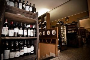 a room filled with lots of bottles of wine at Hotel Regina in Pinerolo