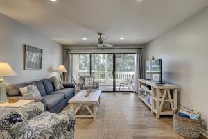 a living room with a couch and a table at Wonderful luxury condo with great golf views K Bed Beach gear & bike rentals in Hilton Head Island