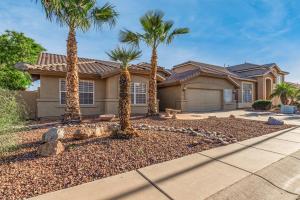 a house with palm trees in front of it at Baylor Gilbert in Gilbert