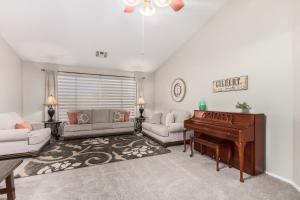 a living room with a piano and a couch at Baylor Gilbert in Gilbert +43 photos