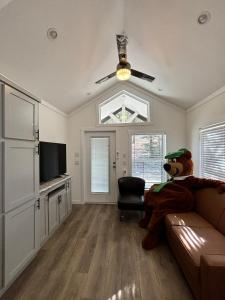 a living room with a teddy bear sitting on a couch at Yogi Bear's Jellystone Park Camp-Resort in Estes Park in Estes Park