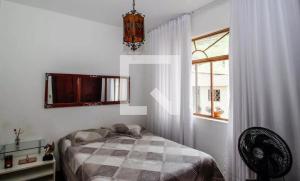 Ένα ή περισσότερα κρεβάτια σε δωμάτιο στο Quarto em Hostel Bh - Sereno