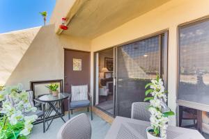 a patio with a table and chairs on a balcony at Mtn-View Condo with Pool Access in Palm Springs! in Palm Springs